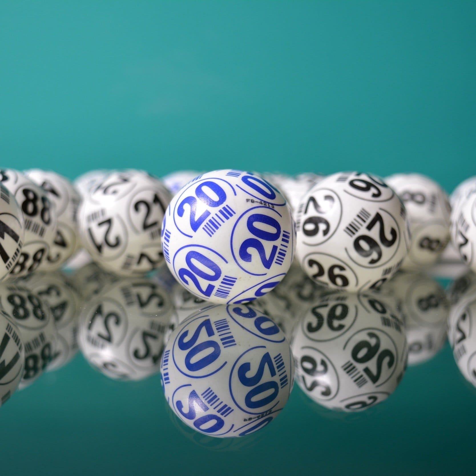A hand selecting a lottery ball.