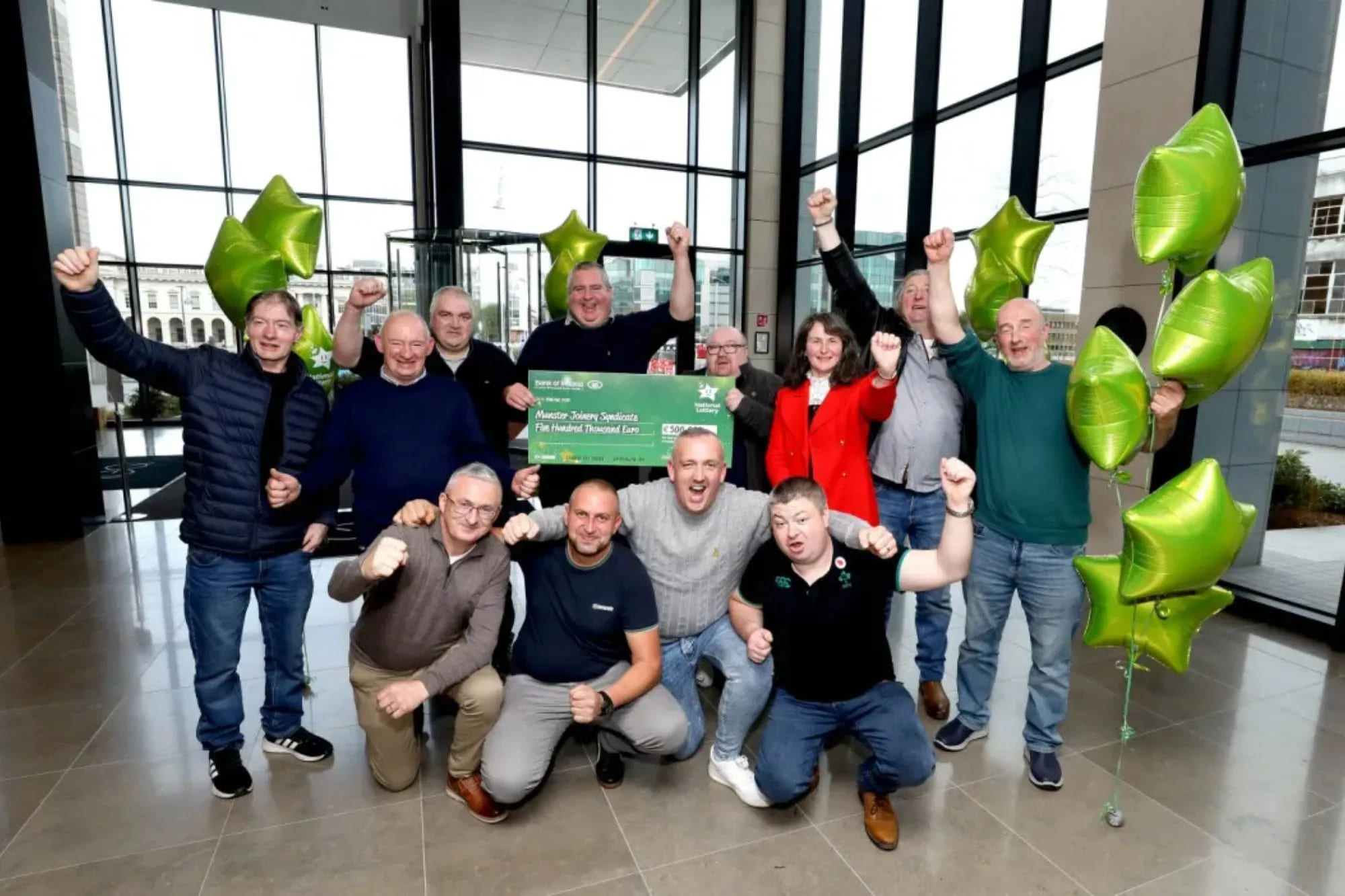 A group of people celebrating a win, representing a lottery syndicate.