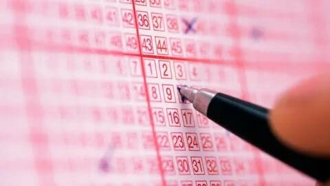 A calculator and tax forms next to lottery tickets.